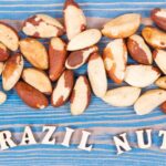 Lots of Brazil nuts raw over the words Brazil Nuts