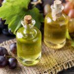 Two bottles of white balsamic vinegar with grapes