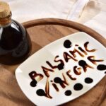 Balsamic vinegar calories in a bottle on a tray with sign