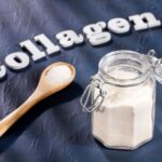 Collagen superfood in a jar next to wooden spoon