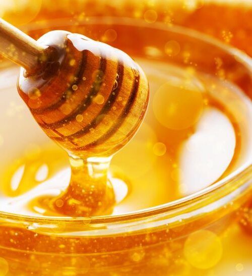 Superfood honey in a bowl with stirrer