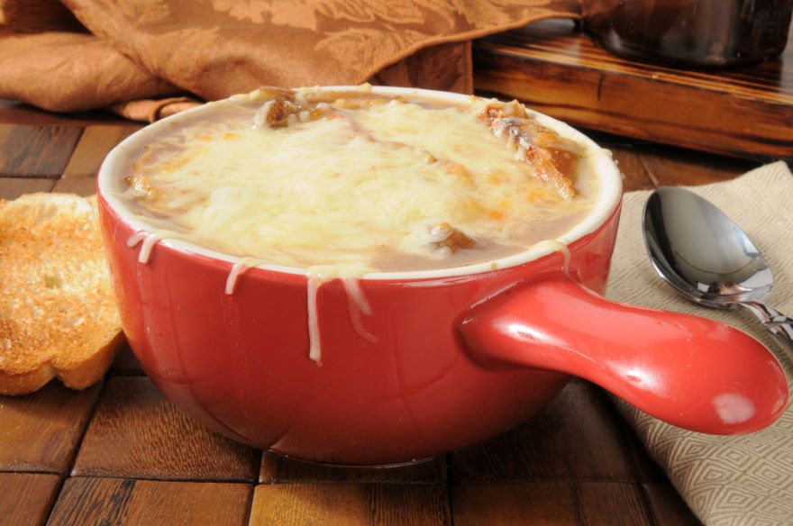 Gluten-free French onion soup in a red bowl