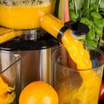 Best juicers with orange juice being squeezed