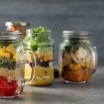Freezer-safe containers full of vegetable salads