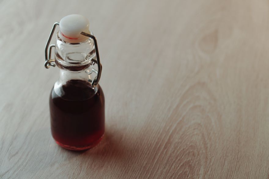 Is malt vinegar gluten-free? in a bottle on wooden background