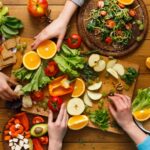 Nutritarian recipes with hands taking fruit and veg from a platter