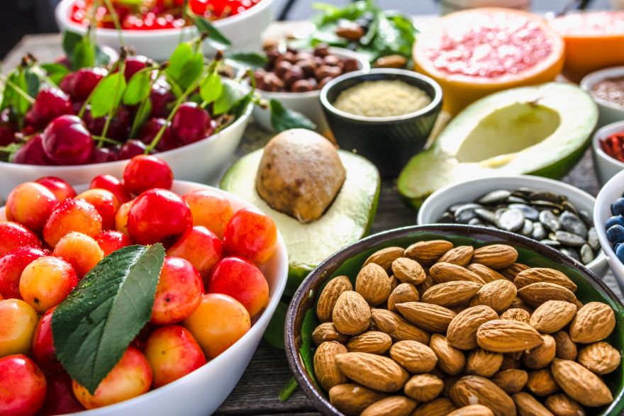 Whole-food plant-based snacks with bowls of fruit and nuts