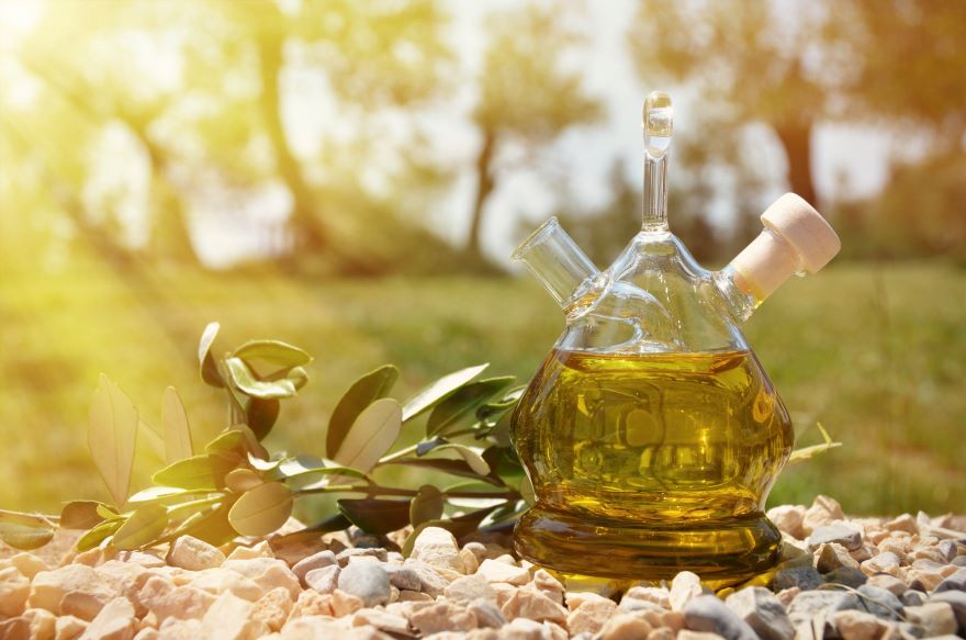 Best olive oil brands with bottle of oil with scenic background