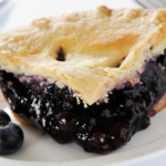 Blueberry pie with frozen blueberries with a slice of pie