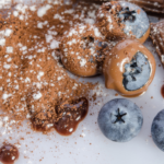 Chocolate covered blueberries next to chocolate