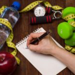 MetaBoost fat flush with fruit, water, tape measure