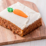 Carrot pulp cake with a carrot on top in icing