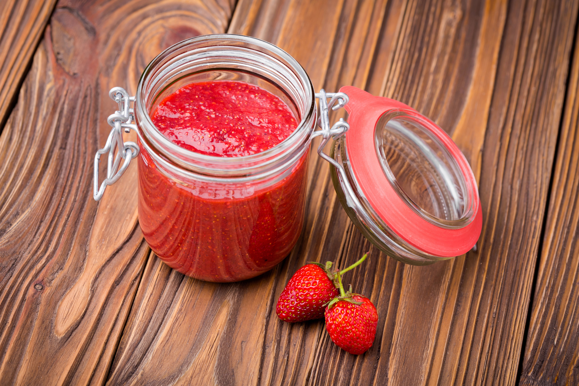 Chia Seed Jam in jar next to strawberries