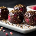 Chocolate covered raspberries on a white plate