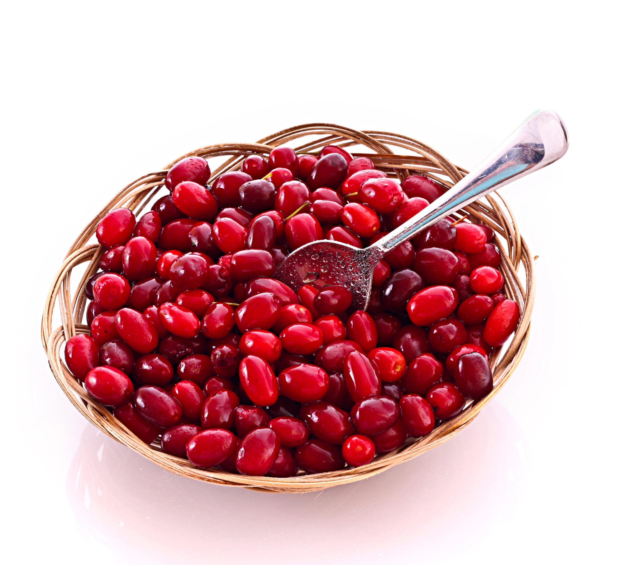 Do cranberries have seeds? with a spoon in a bowl on white background