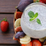 Chia seed pudding in a glass dish with fruit around