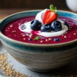 Antioxidant-rich berry and beet chilled superfood soup in bowl with berries on top
