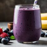 Brain-boosting blueberry and acai power smoothie with berries next to glass
