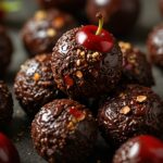 Dark chocolate cherry quinoa energy bites with a few on a plate
