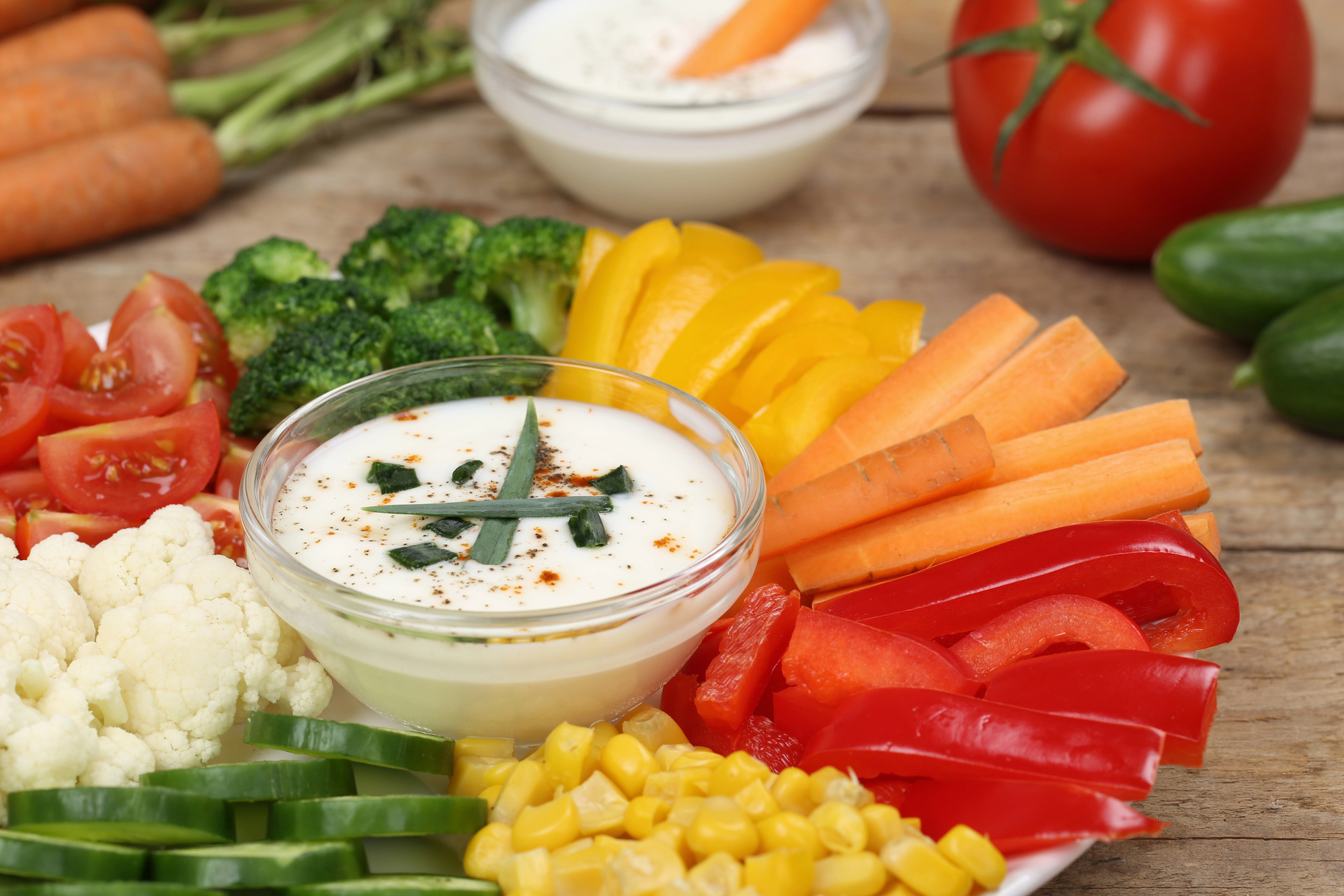 Kefir ranch dip with fresh veggie sticks on a plate with dip in the middle