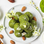 Matcha green tea energy bites with a few nuts beside