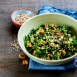 One-pot quinoa and frozen spinach protein bowl with lemon tahini drizzle in a white bowl