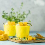 Organic turmeric and mango smoothie with two glasses