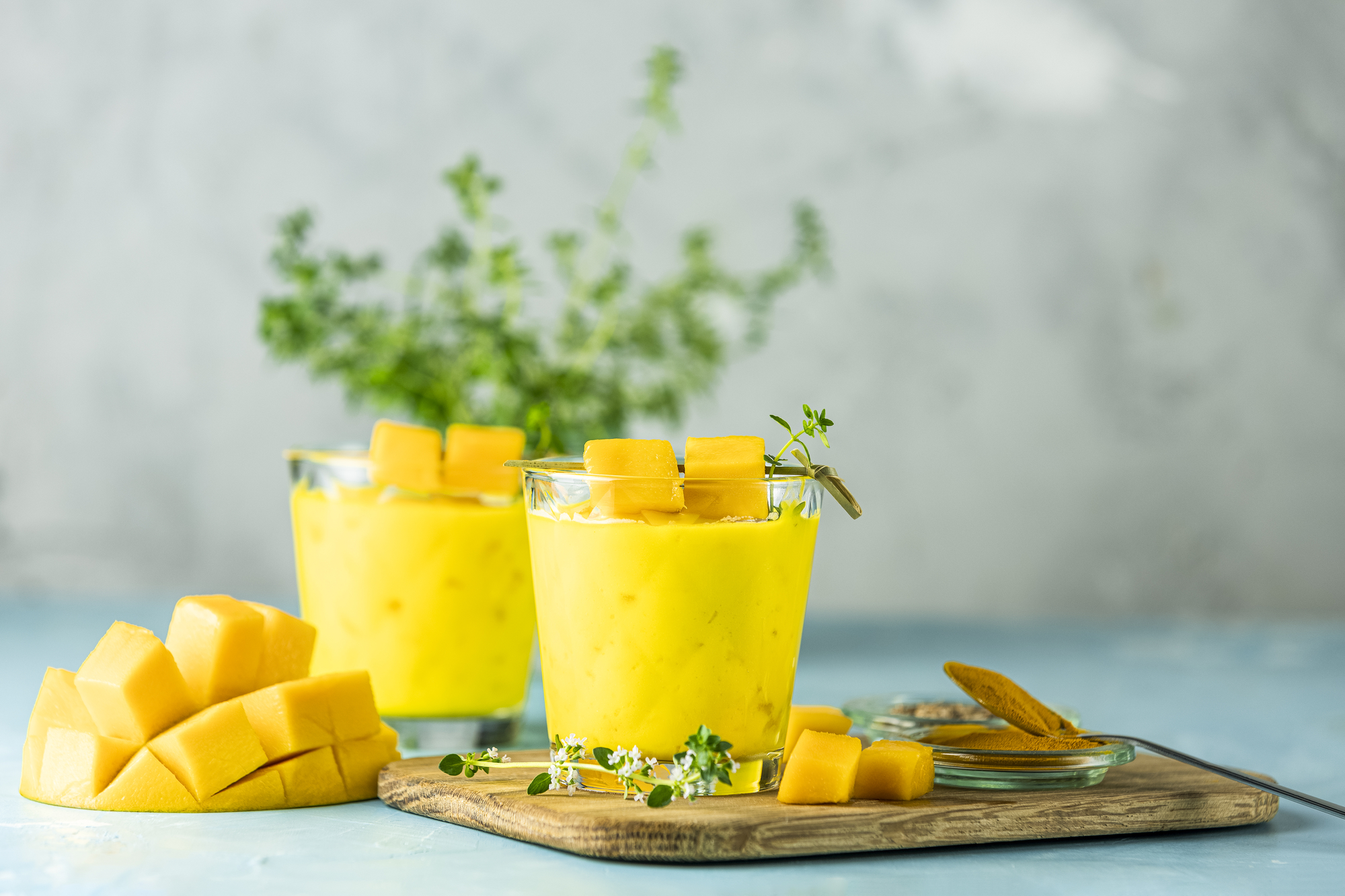 Organic turmeric and mango smoothie with two glasses