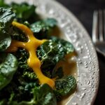 Spinach and kale salad with superfood honey mustard dressing with a closeup view of salad