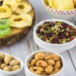 Gluten-free and dairy-free snacks with fruit, nuts in bowls