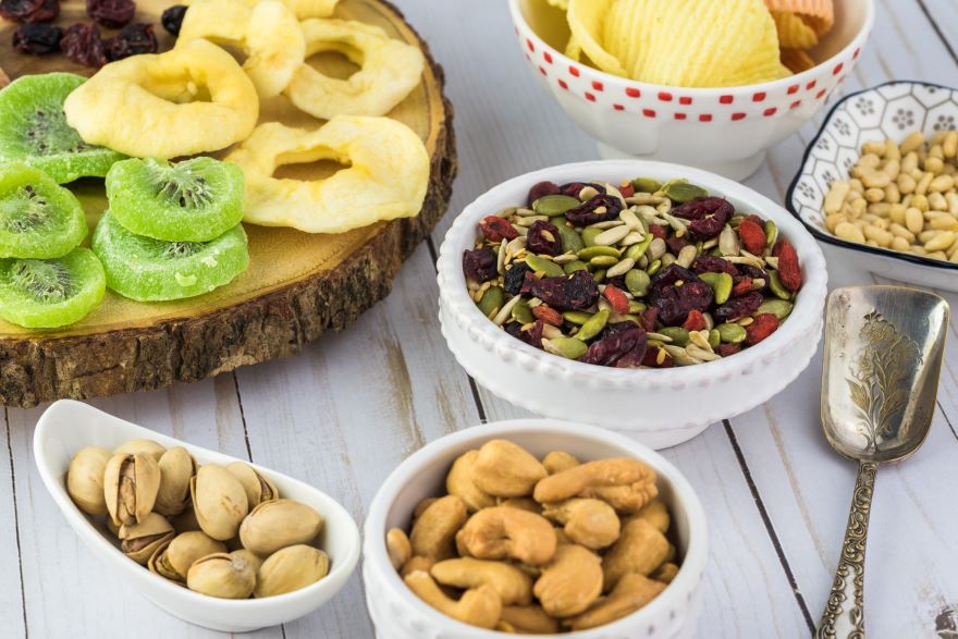 Gluten-free and dairy-free snacks with fruit, nuts in bowls