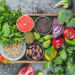 Superfoods with fruit, vegetables, seeds on a tray