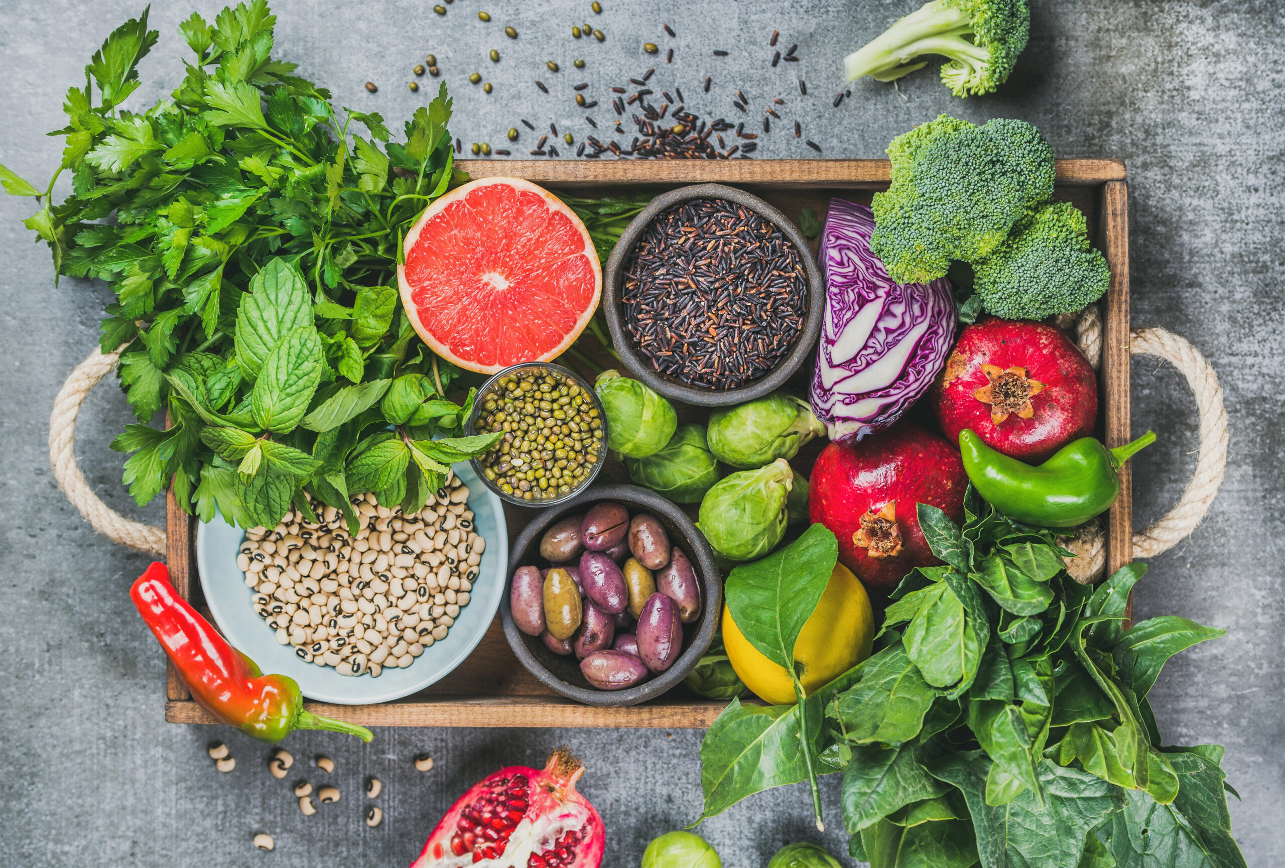 Superfoods with fruit, vegetables, seeds on a tray